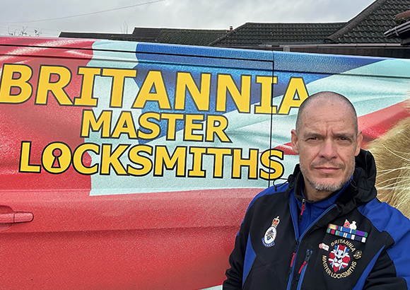 Richard Lewer, founder of Britannia Locksmiths, standing in front of his company's van